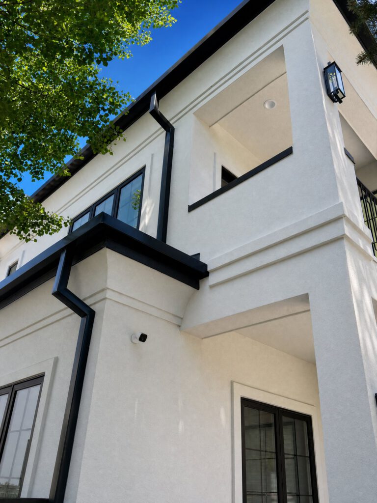 Black downspout and gutter corner detail