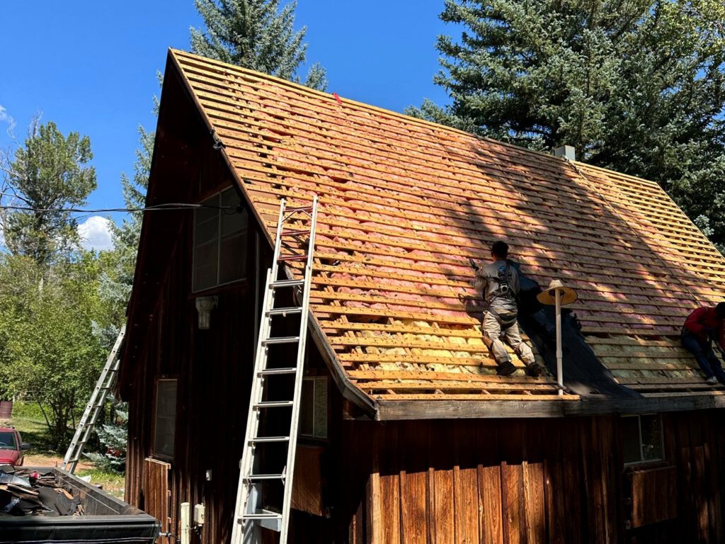 Mid-restoration: the cedar shake roof torn off to the decking