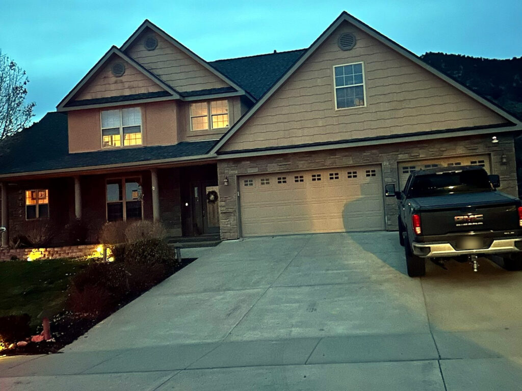 A completed residential roof, photographed at dusk