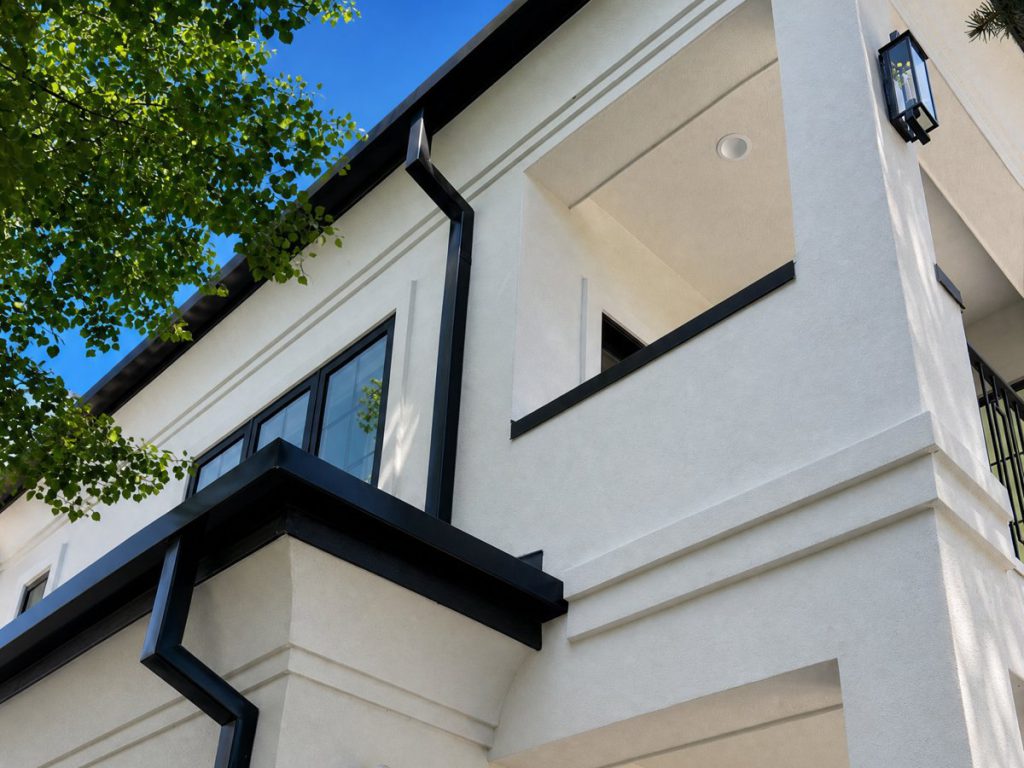 Black downspout and gutter corner detail