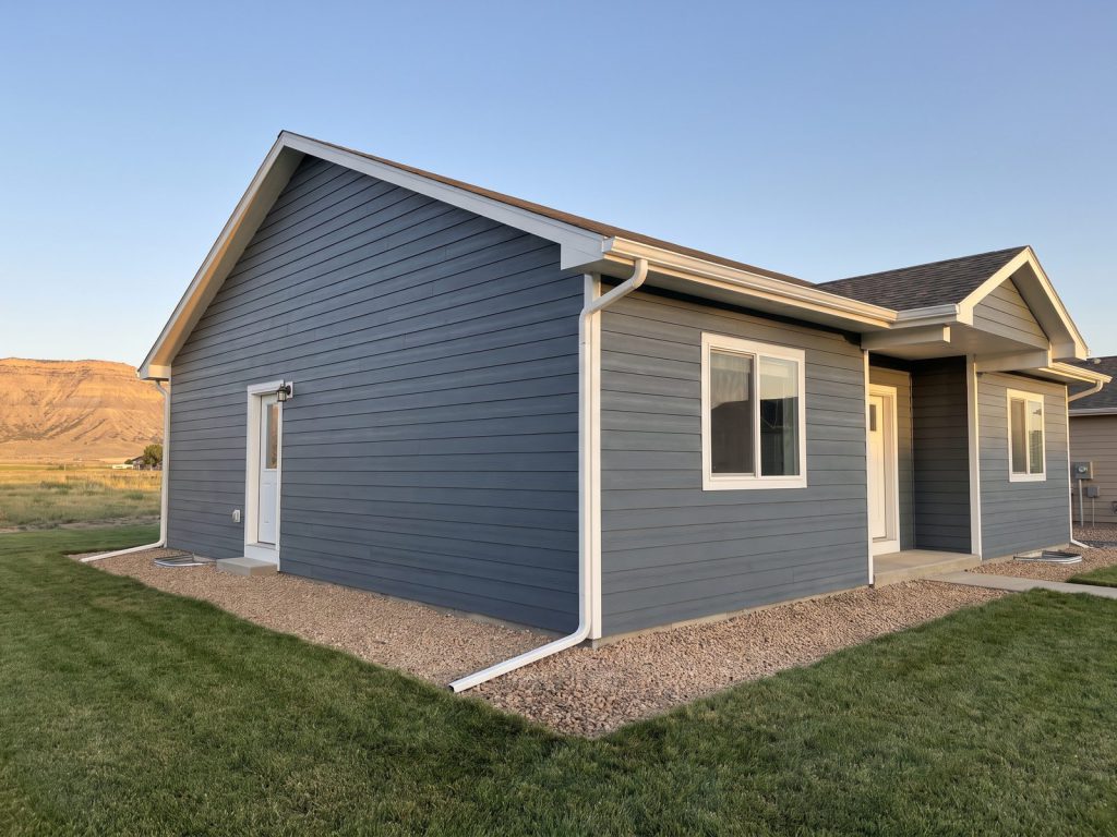 Ranch home finished in new blue-gray lap siding with white trim